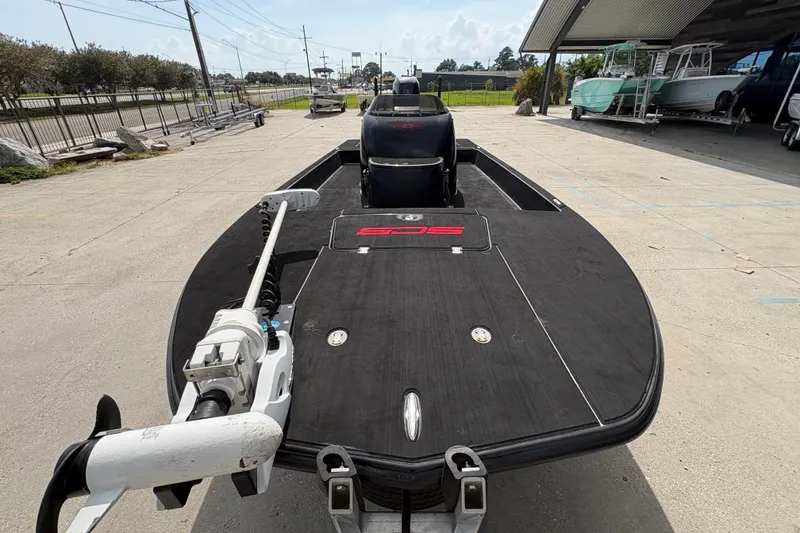 Slide: The Image of 2016 SCB 247 boat with trolling motor on trailer, parked outdoors. - 11