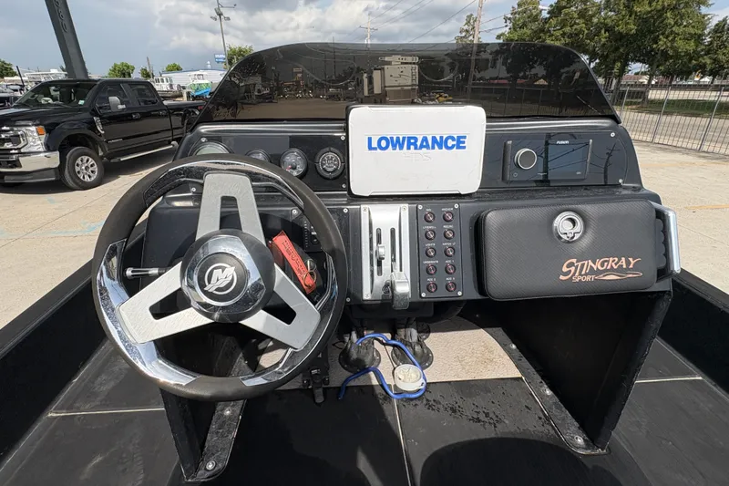 Slide: The Image of 2016 SCB 247 boat dashboard with steering wheel, Lowrance GPS, and Stingray Sport panel. - 19