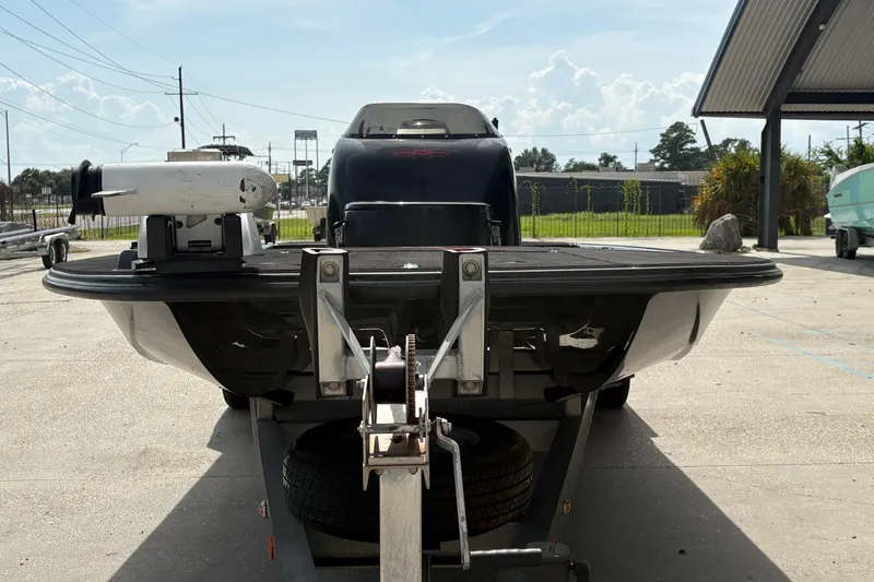 Slide: The Image of 2016 SCB 247 boat on trailer, parked outdoors under a clear sky. - 9