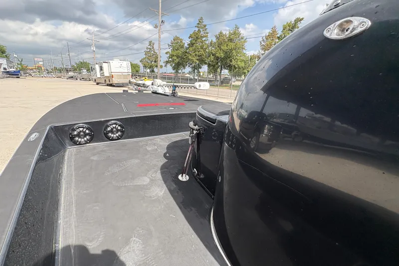 Slide: The Image of 2016 SCB 247 boat deck with speakers, parked outdoors under cloudy sky. - 20