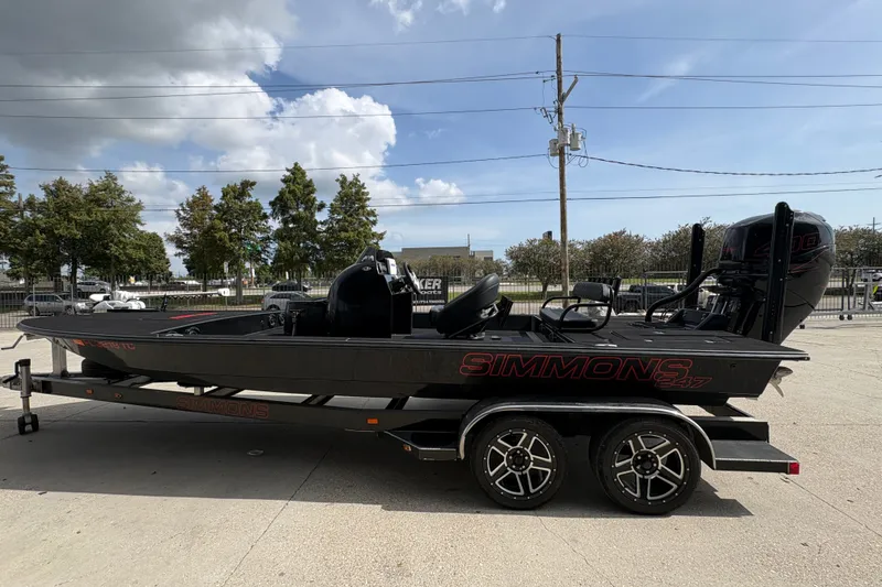Slide: The Image of 2016 SCB 247 boat on trailer, parked outdoors under a partly cloudy sky. - 7