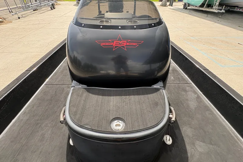 Slide: The Image of 2016 SCB 247 boat with custom logo, black finish, and sleek design on a trailer. - 21