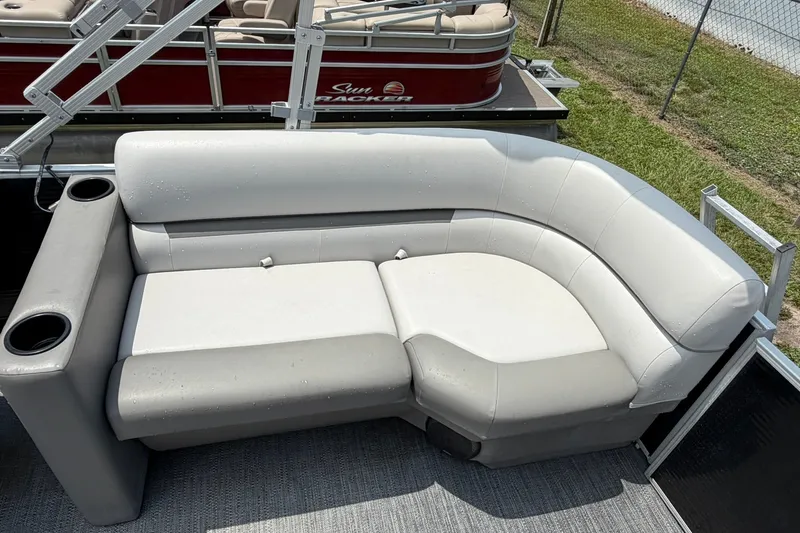 Slide: The Image of 2022 Sweetwater 2286 SBX pontoon boat with gray and white seating and cup holders. - 13