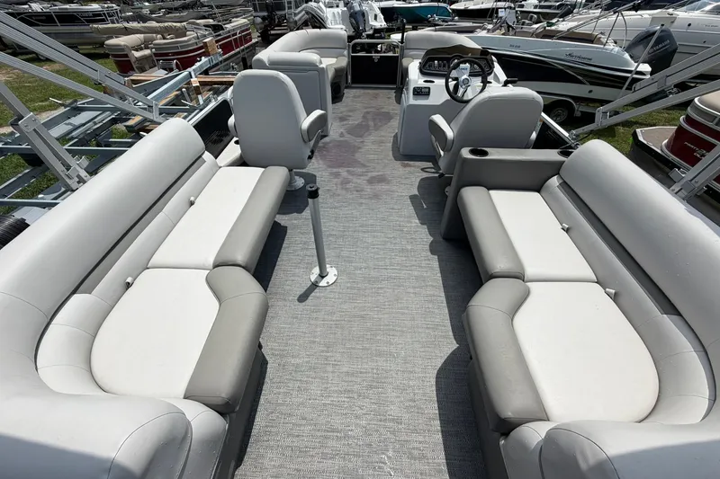 Slide: The Image of 2022 Sweetwater 2286 SBX pontoon boat interior with spacious seating and steering console. - 14