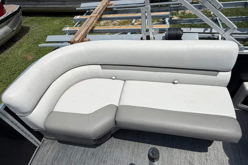 Slide: The Image of 2022 Sweetwater 2286 SBX boat with white and gray cushioned seating. - 12
