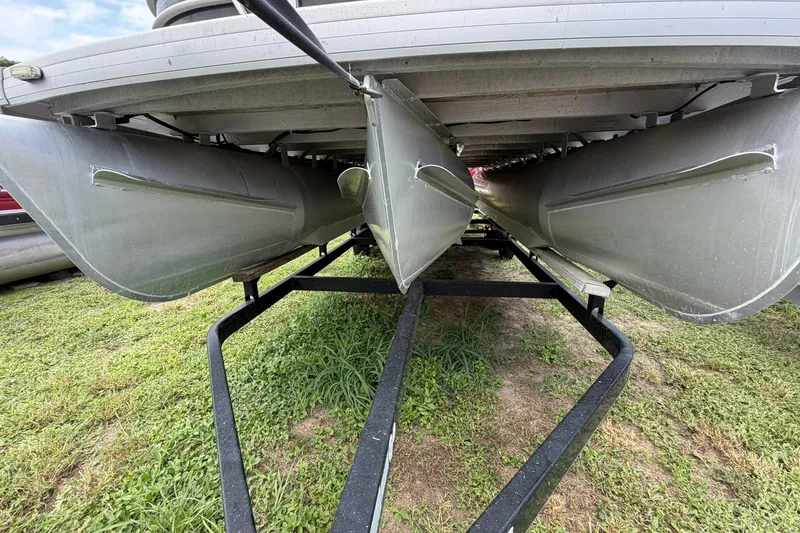 Slide: The Image of Underneath view of a 2022 Sweetwater 2286 SBX pontoon boat on a trailer. - 2