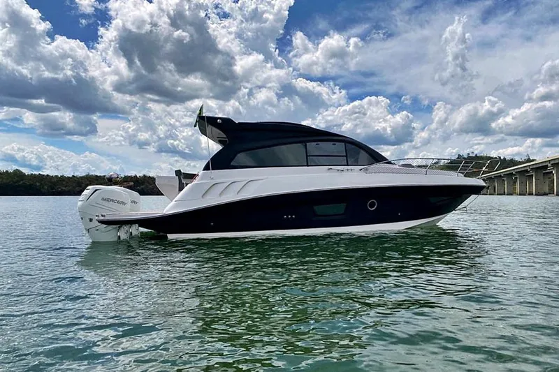 Slide: The Image of Luxury Hanover 355 boat on water, 2026 model, under a partly cloudy sky. - 1