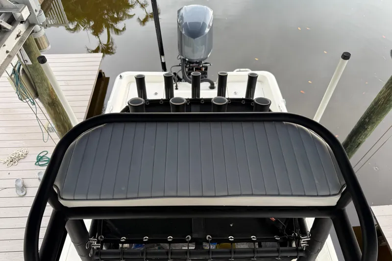 Slide: The Image of 2021 Skeeter SX2550 Fish boat with rod holders and motor, docked by wooden pier. - 42
