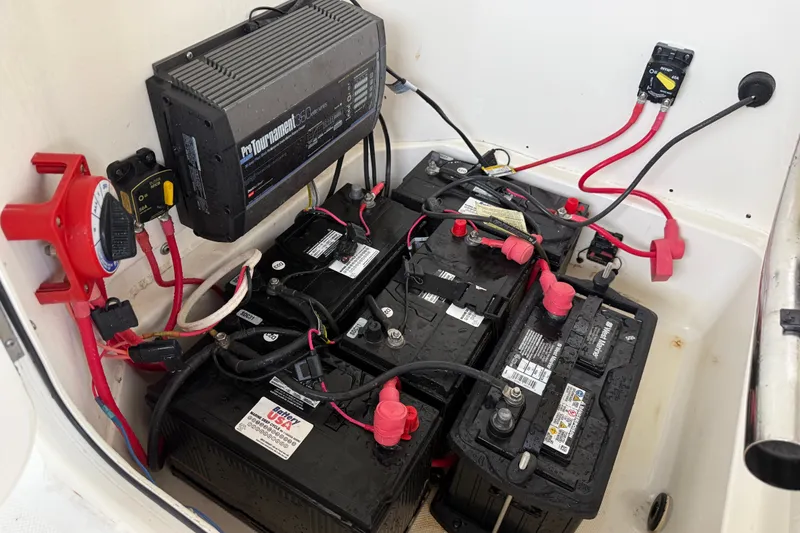 Slide: The Image of Battery compartment of a 2021 Skeeter SX2550 Fish boat with wiring and charger. - 30
