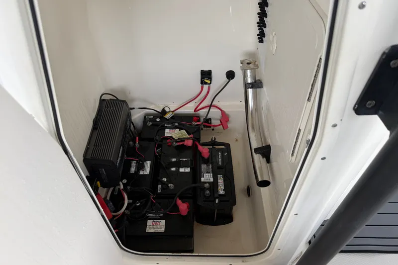 Slide: The Image of Battery compartment of a 2021 Skeeter SX2550 Fish boat, featuring multiple batteries and wiring. - 29