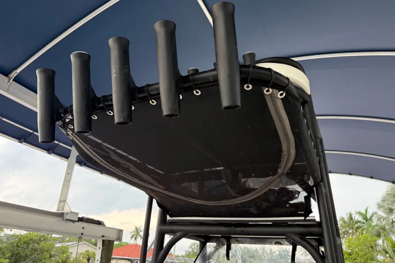 Slide: The Image of 2021 Skeeter SX2550 Fish boat with rod holders under a blue canopy. - 31