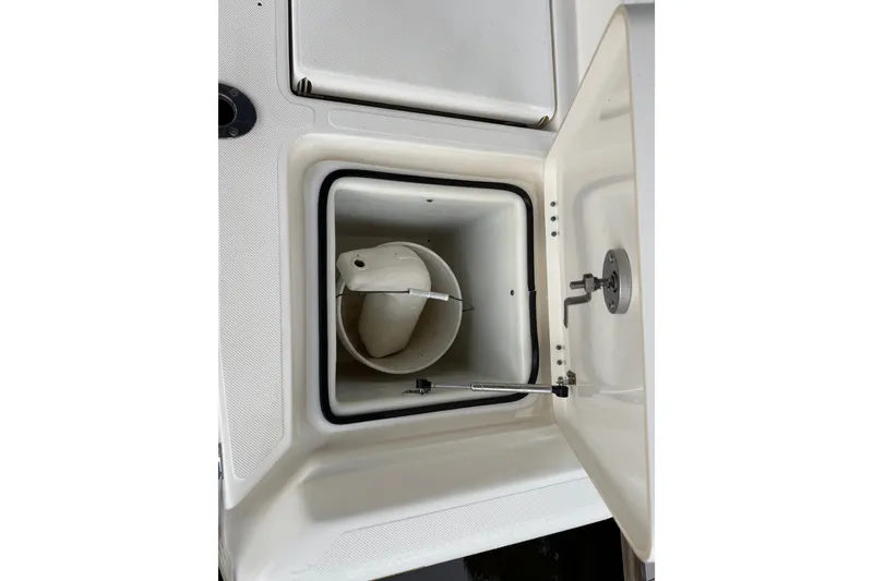 Slide: The Image of Open storage compartment on 2021 Skeeter SX2550 Fish boat, featuring a white interior. - 15