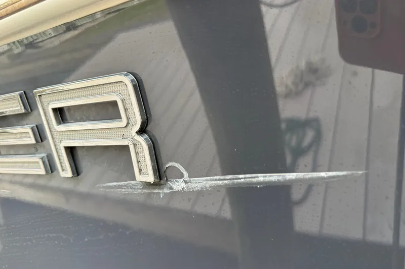 Slide: The Image of Close-up of a scratch on a 2021 Skeeter SX2550 Fish boat's exterior. - 7
