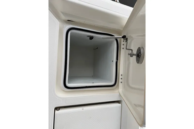 Slide: The Image of Open storage compartment on a 2021 Skeeter SX2550 Fish boat. - 16