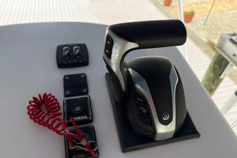 Slide: The Image of Control panel of a 2021 Skeeter SX2550 Fish boat with Yamaha throttle and safety lanyard. - 41