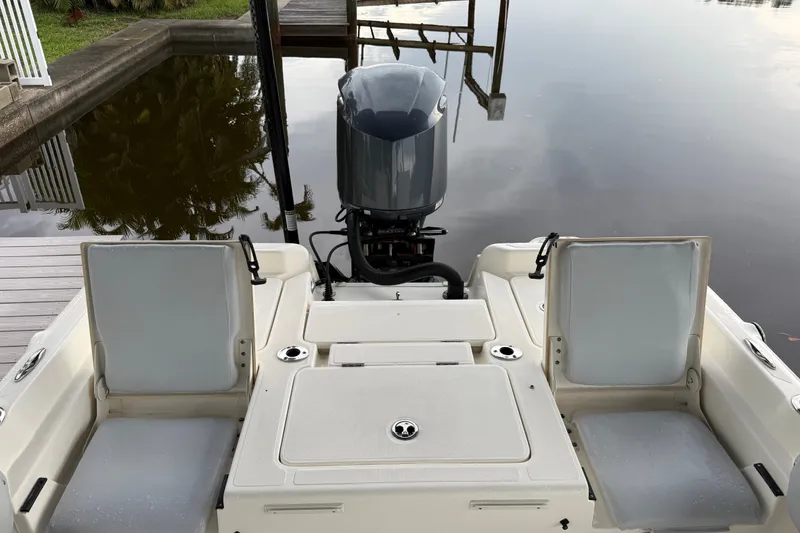 Slide: The Image of 2021 Skeeter SX2550 Fish boat with outboard motor, docked by calm water. - 13