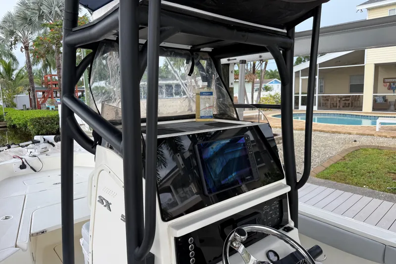 Slide: The Image of 2021 Skeeter SX2550 Fish boat dashboard with navigation system, near a poolside setting. - 22