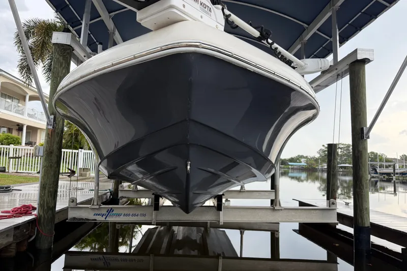 Slide: The Image of 2021 Skeeter SX2550 Fish boat on lift, docked by waterfront homes. - 3