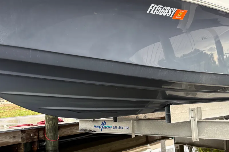 Slide: The Image of 2021 Skeeter SX2550 Fish boat on a lift, displaying Florida registration. - 4