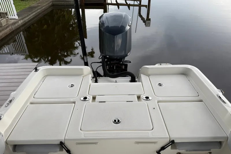 Slide: The Image of 2021 Skeeter SX2550 Fish boat with outboard motor, docked on calm water. - 12