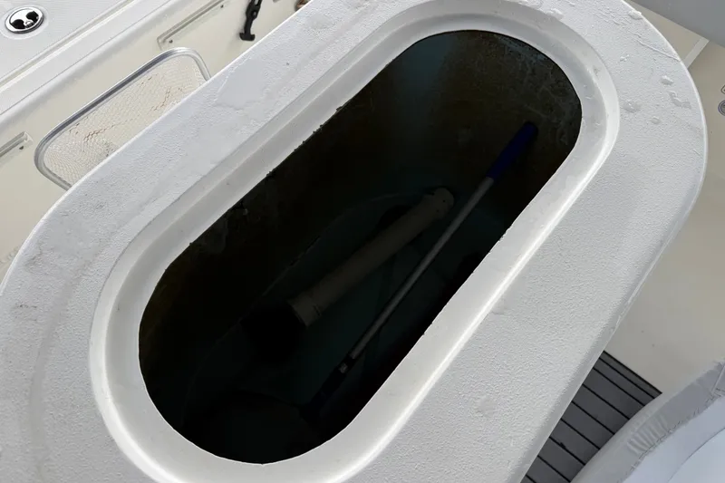 Slide: The Image of Livewell compartment on a 2021 Skeeter SX2550 Fish boat, featuring a white interior. - 20
