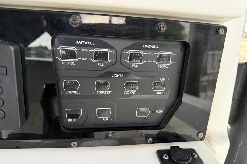 Slide: The Image of Control panel of a 2021 Skeeter SX2550 Fish boat, featuring baitwell and livewell switches. - 25