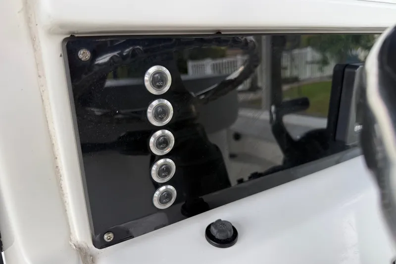 Slide: The Image of Control panel of 2021 Skeeter SX2550 Fish boat with accessory buttons. - 24