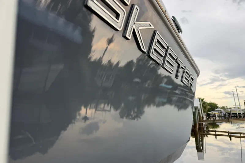 Slide: The Image of Close-up of 2021 Skeeter SX2550 Fish boat with reflective water surface. - 6