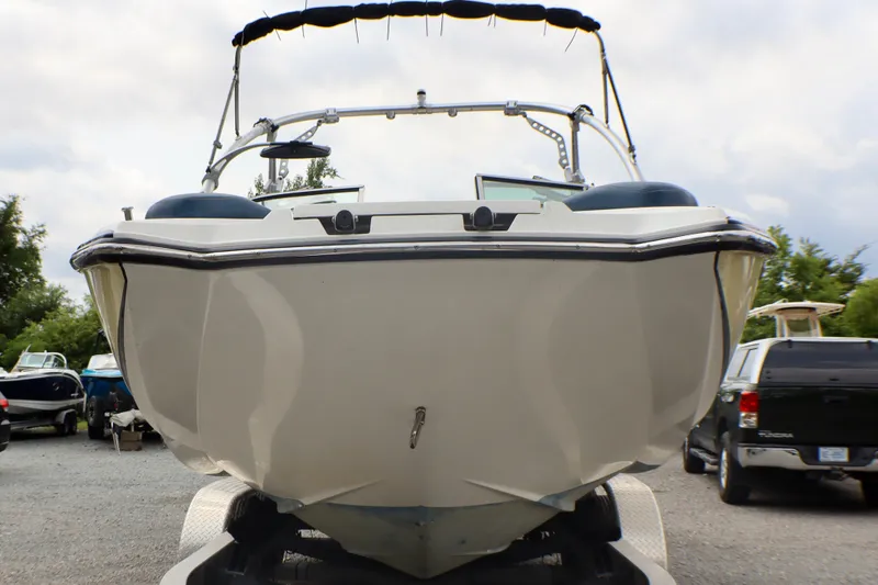 Slide: The Image of 2010 MasterCraft X-35 SS boat on trailer, front view, parked outdoors. - 2