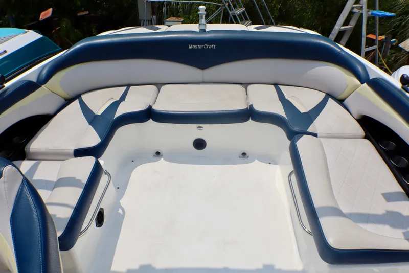 Slide: The Image of 2010 MasterCraft X-35 SS boat interior with white and blue seating arrangement. - 21