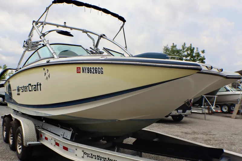 Slide: The Image of 2010 MasterCraft X-35 SS boat on trailer, side view, with registration number NY9626GG. - 1