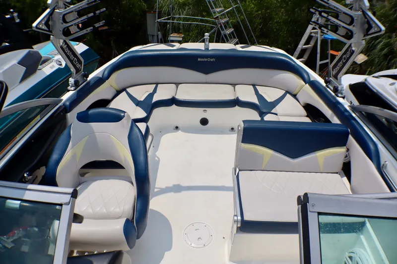 Slide: The Image of 2010 MasterCraft X-35 SS boat interior with blue and white seating. - 11
