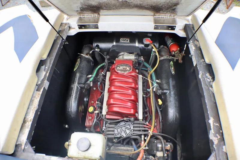 Slide: The Image of 2010 MasterCraft X-35 SS engine compartment with red MCX engine and components. - 23