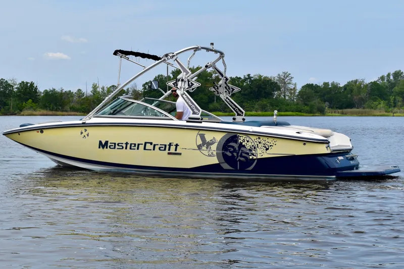 Slide: The Image of 2010 MasterCraft X-35 SS boat on calm water, featuring sleek design and vibrant graphics. - 39