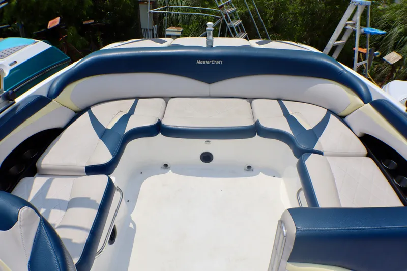 Slide: The Image of 2010 MasterCraft X-35 SS boat interior with blue and white seating arrangement. - 12