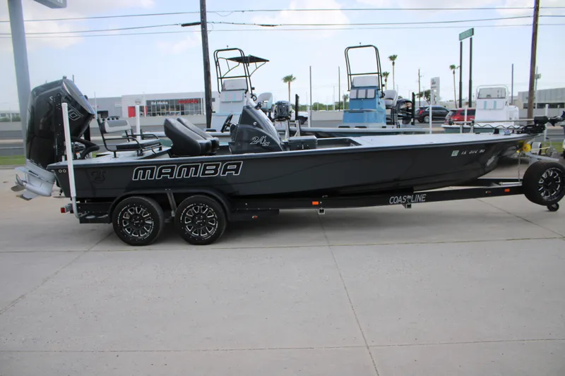 Slide: The Image of 2025 Mamba 24VX boat on trailer, sleek design, parked outdoors. - 1