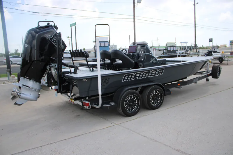 Slide: The Image of 2025 Mamba 24VX boat on trailer, featuring powerful outboard motor and sleek design. - 9