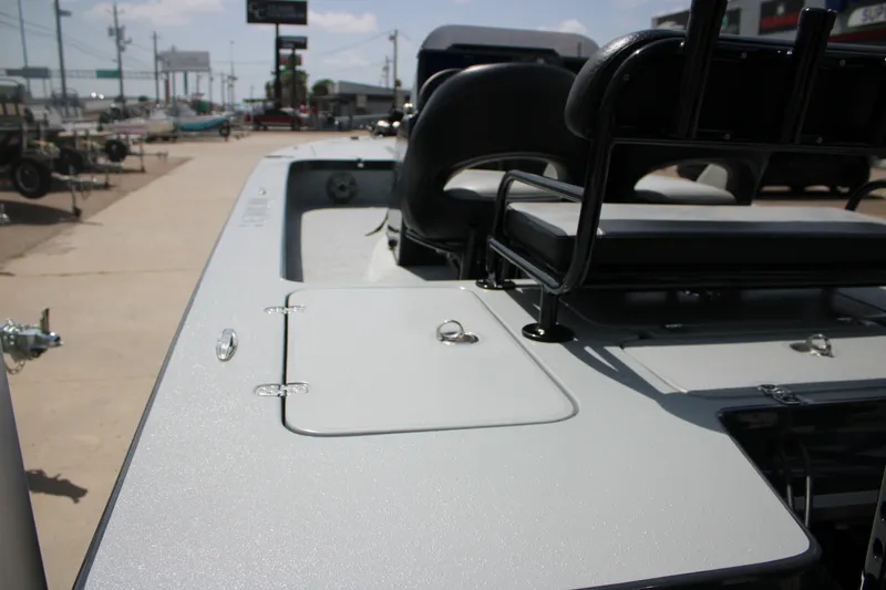 Slide: The Image of 2025 Mamba 24VX boat deck with seating, parked outdoors on a sunny day. - 5