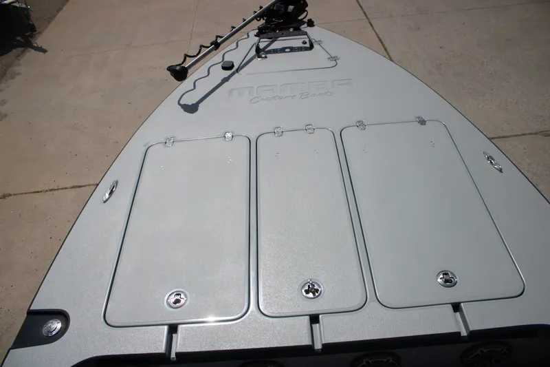 Slide: The Image of 2025 Mamba 24VX boat deck with storage compartments and trolling motor. - 11