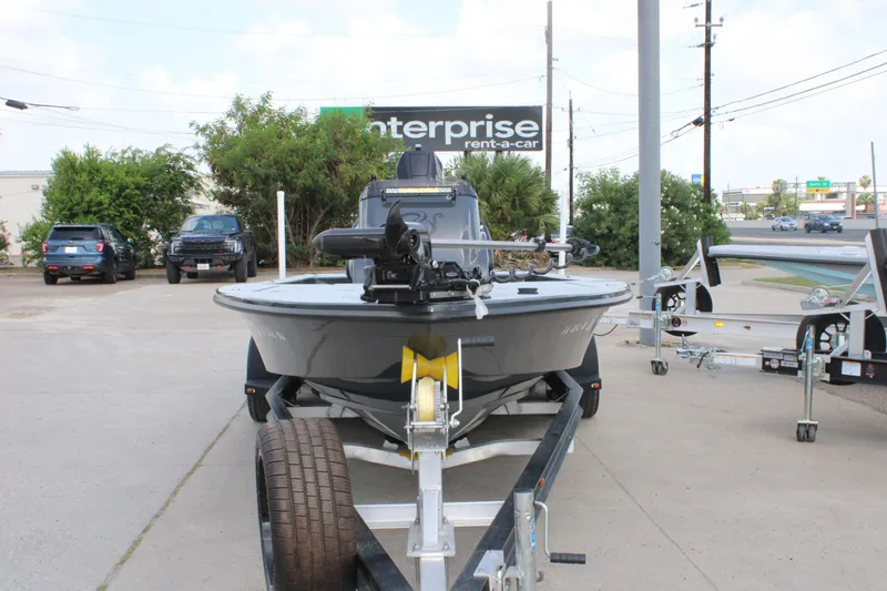 Slide: The Image of 2025 Mamba 24VX boat on trailer in parking lot, near Enterprise Rent-A-Car sign. - 18