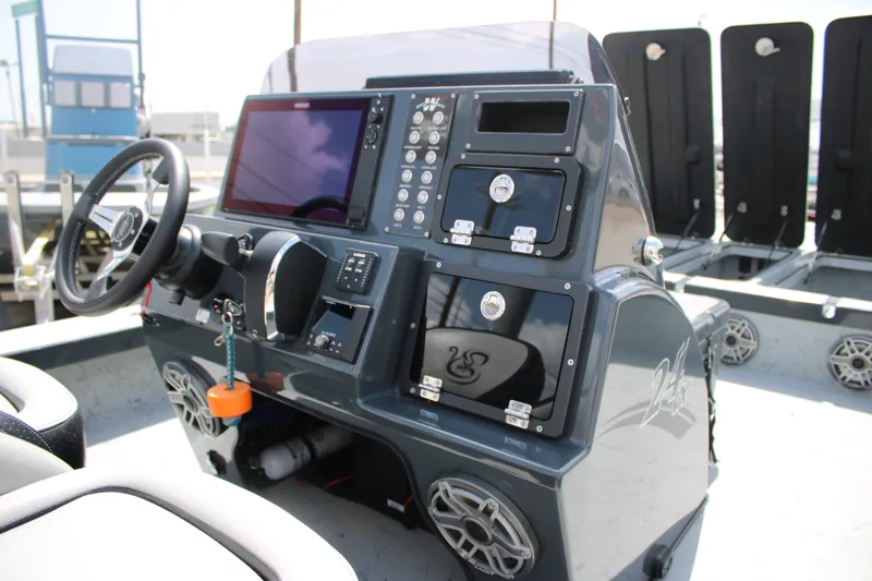 Slide: The Image of Control panel of 2025 Mamba 24VX boat with steering wheel and electronic displays. - 17