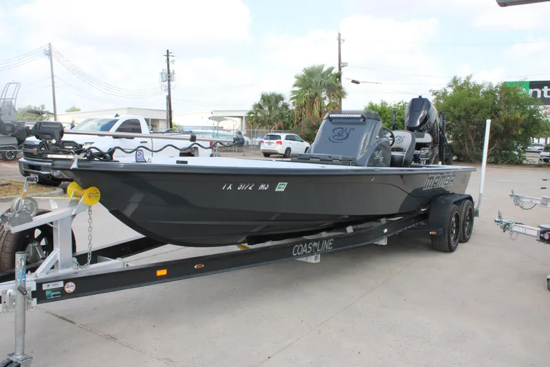Slide: The Image of 2025 Mamba 24VX boat on trailer, parked outdoors, featuring sleek design and modern equipment. - 3