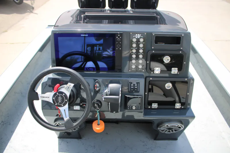 Slide: The Image of 2025 Mamba 24VX boat dashboard with steering wheel and control panel. - 16
