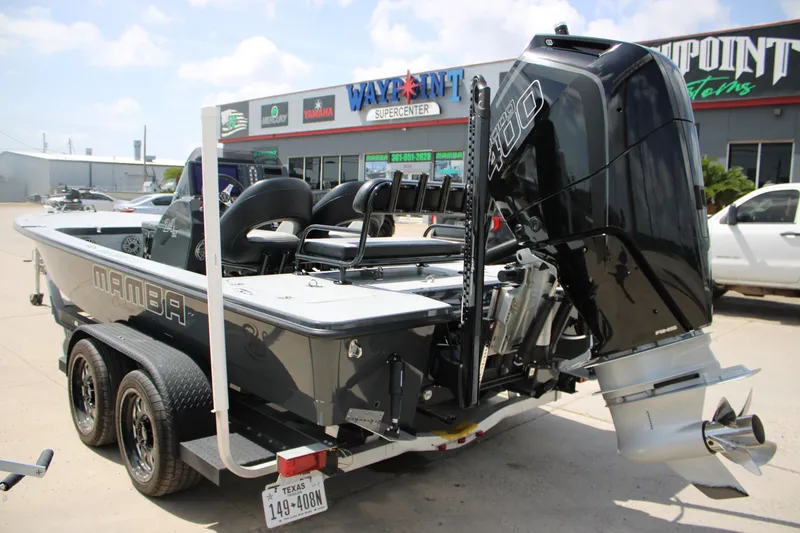 Slide: The Image of 2025 Mamba 24VX boat with powerful engine on trailer at dealership. - 2