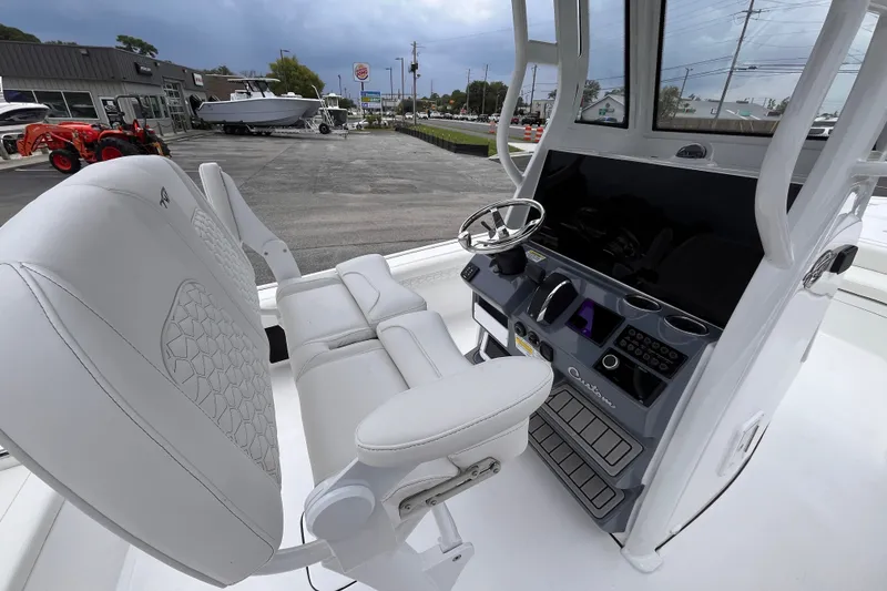 Slide: The Image of 2027 Tidewater 2500 Carolina Bay boat interior with modern helm and seating. - 8