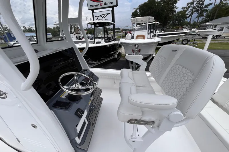 Slide: The Image of 2027 Tidewater 2500 Carolina Bay boat interior with steering wheel and seating at Marker 17 Marine. - 15