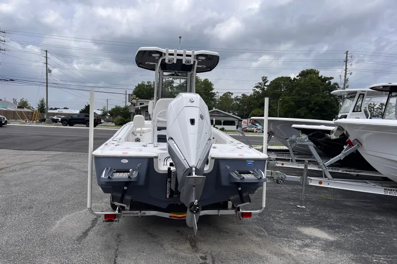 Slide: The Image of 2027 Tidewater 2500 Carolina Bay boat with outboard motor, parked on a trailer. - 3