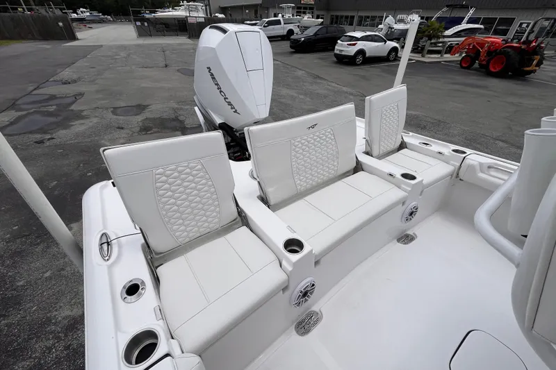 Slide: The Image of 2027 Tidewater 2500 Carolina Bay boat interior with white seating and Mercury engine. - 7