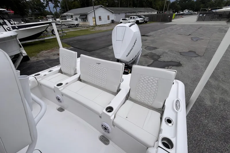 Slide: The Image of 2027 Tidewater 2500 Carolina Bay boat with Mercury engine, featuring white seating and cup holders. - 17
