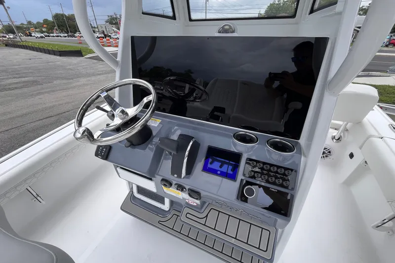 Slide: The Image of 2027 Tidewater 2500 Carolina Bay boat console with steering wheel and control panel. - 9